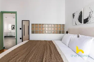 a bedroom with a large bed in a room at Sunlit Balcony Family APT Whirpool & Netflix in Athens