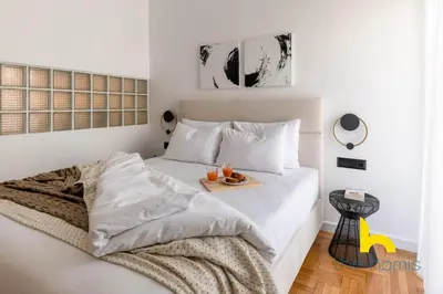 a white bed with a tray of food on it at Sunlit Balcony Family APT Whirpool & Netflix in Athens