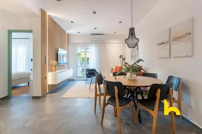 a dining room and living room with a table and chairs at Sunlit Balcony Family APT Whirpool & Netflix in Athens