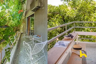 a balcony of a house with a table and chairs at Retro Radiance Artistic Haven Near Acropolis in Athens