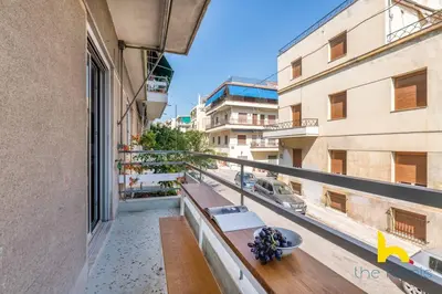 an apartment balcony with a view of a street at Retro Radiance Artistic Haven Near Acropolis in Athens