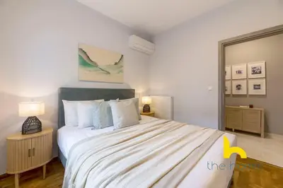 a bedroom with a large bed in a room at Sun Splashed Sanctum w Green Patio, Acropolis in Athens