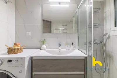 a bathroom with a sink and a washing machine at Sun Splashed Sanctum w Green Patio, Acropolis in Athens