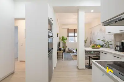 a kitchen with white appliances and a dining room at The Urban Jungle Escape Corner APT Near Acropolis in Athens