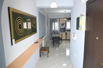 a hallway with a living room and a dining room at Christoffer Mpournazi Penthouse in Athens