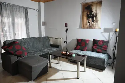 a living room with a couch and a table at Christoffer Mpournazi Penthouse in Athens