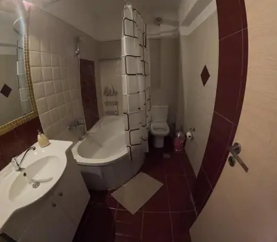 a small bathroom with a sink and a toilet at Christoffer Mpournazi Penthouse in Athens