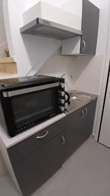 a microwave oven sitting on a counter in a kitchen at Harbor View Apartment Athens in Piraeus