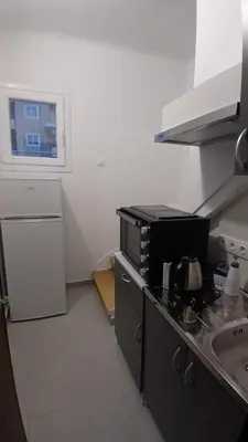 a small kitchen with a stove and a sink at Harbor View Apartment Athens in Piraeus