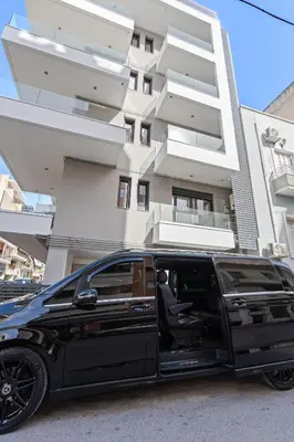 a black limousine parked in front of a building at Athens Vein in Athens
