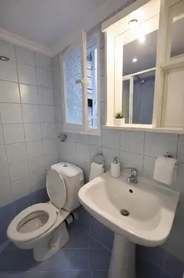 a bathroom with a toilet and a sink at Zwgrafou Deluxe For 4 Pers in Athens