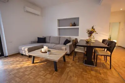 a living room with a couch and a table at Zwgrafou Deluxe For 4 Pers in Athens