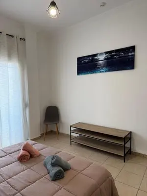 a bedroom with a large bed and a table at Bakopoulos resort στο Μπουρνάζι in Athens