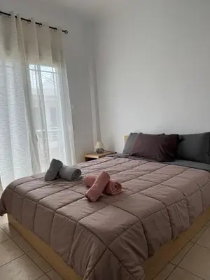 a large bed with two stuffed animals on top of it at Bakopoulos resort στο Μπουρνάζι in Athens