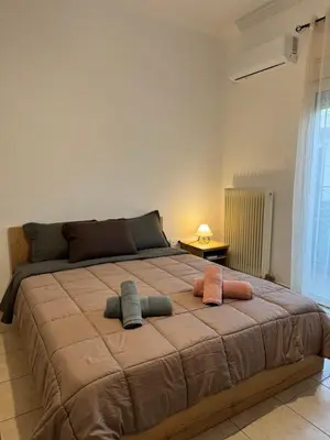 a bedroom with a large bed with two pillows on it at Bakopoulos resort στο Μπουρνάζι in Athens