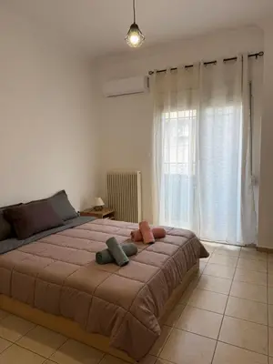 a bedroom with a large bed with two pillows on it at Bakopoulos resort στο Μπουρνάζι in Athens