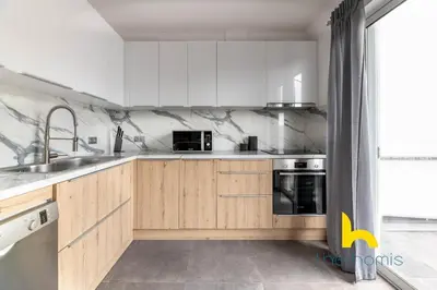 a kitchen with white cabinets and stainless steel appliances at Sunny Athenian Oasis Spacious Family Haven! in Athens