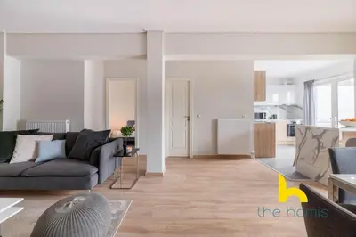 a living room with a couch and a table at Sunny Athenian Oasis Spacious Family Haven! in Athens