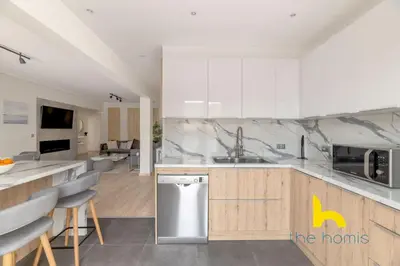 a kitchen with a sink and a counter top at Sunny Athenian Oasis Spacious Family Haven! in Athens