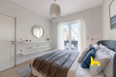 a white bedroom with a bed and a mirror at Sunny Athenian Oasis Spacious Family Haven! in Athens