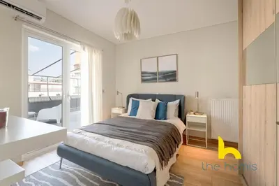 a bedroom with a large bed with blue pillows at Sunny Athenian Oasis Spacious Family Haven! in Athens