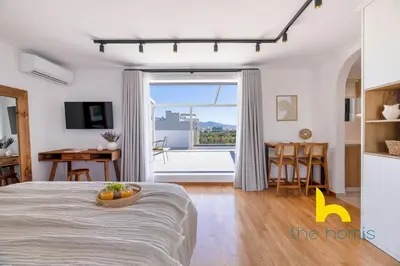 a bedroom with a bed and a large window at Eagle's Nest Athens Oasis with Culture & Views! in Athens