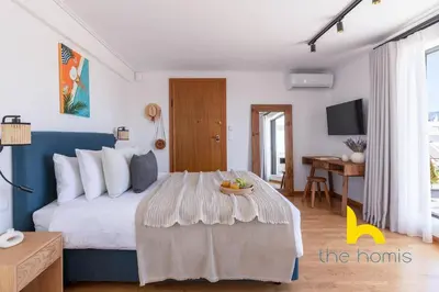 a bedroom with a bed and a table with a bowl of fruit on it at Eagle's Nest Athens Oasis with Culture & Views! in Athens