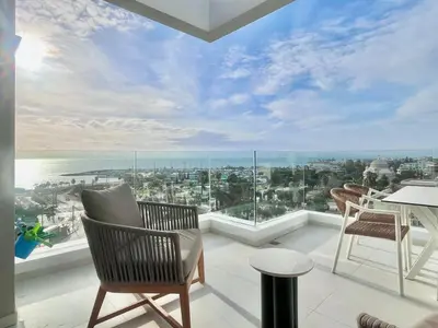 a balcony with chairs and a view of the ocean at Penthouse with private pool and unlimited Sea View in Glyfádas