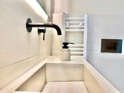 a sink in a bathroom with a faucet at Penthouse with private pool and unlimited Sea View in Glyfádas