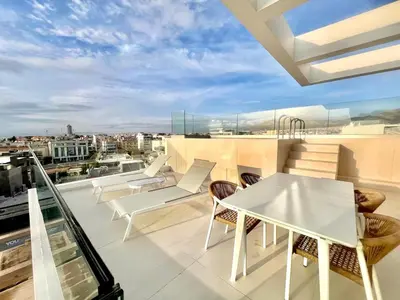 a balcony with a white table and chairs at Penthouse with private pool and unlimited Sea View in Glyfádas