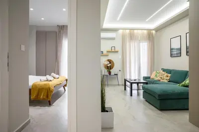 a living room with a green couch and a bed at Central apartment in Piraeus in Piraeus