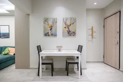 a dining room with a table and two paintings on the wall at Central apartment in Piraeus in Piraeus