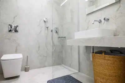 a bathroom with a shower and a toilet and a sink at Central apartment in Piraeus in Piraeus