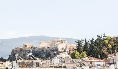 a view of the acropolis of athens from a city at AVM Suites - Grand Thissio Prestige Residence in Athens