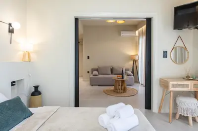a living room with a bed and a couch at AVM Suites - Grand Thissio Prestige Residence in Athens