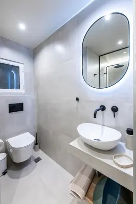 a bathroom with a sink and a mirror at AVM Suites - Grand Thissio Prestige Residence in Athens