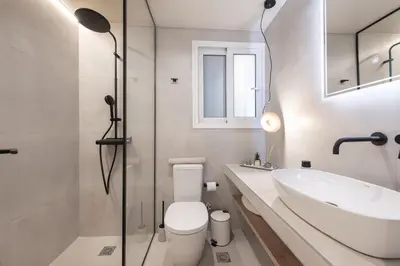 a bathroom with a white toilet and a sink at AVM Suites - Grand Thissio Prestige Residence in Athens