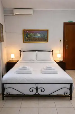 a bedroom with a bed with two towels on it at Zografou Cozy Apartment in the heart of Athens! in Athens