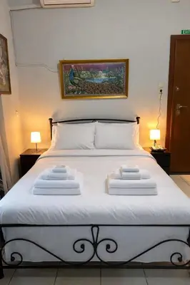 a bedroom with a bed with two towels on it at Zografou Cozy Apartment in the heart of Athens! in Athens