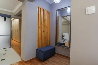 a hallway with a mirror and a blue ottoman at Rhapsody in Blue Alimos Marina in Athens