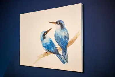 a painting of two blue birds sitting on a branch at Rhapsody in Blue Alimos Marina in Athens