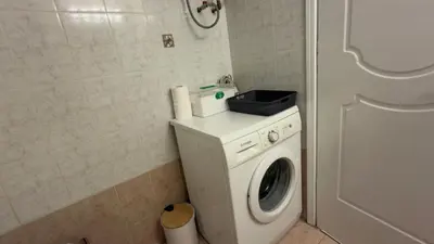 a washer and dryer in a bathroom at The Stylish Central 2BR Residence for 5 in Athens