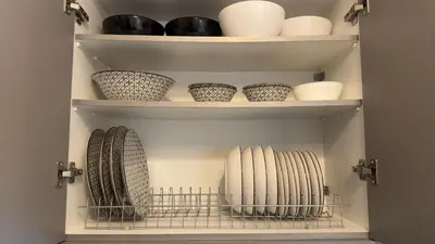 a cupboard filled with bowls and vases at The Stylish Central 2BR Residence for 5 in Athens