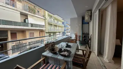 a balcony with a table and chairs in a building at The Stylish Central 2BR Residence for 5 in Athens