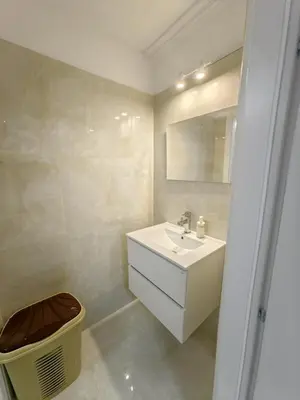 a white bathroom with a sink and a mirror at evaxila papaflessa in Glyka Nera