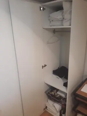 a closet with a white door and some towels at Studio Poseidonos Avenue in Athens
