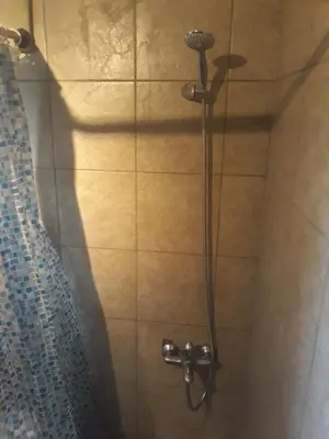 a shower with a shower head in a bathroom at Studio Poseidonos Avenue in Athens