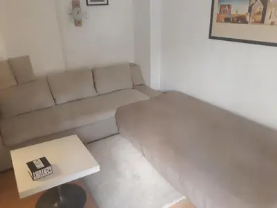 a living room with a couch and a coffee table at Studio Poseidonos Avenue in Athens