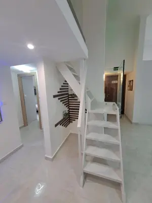 a white staircase in a room with a stair case at Lula Urban Apartment in Athens