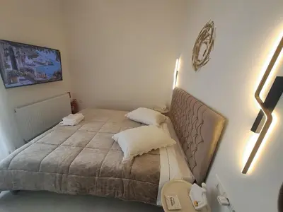 a small bedroom with a bed with two pillows at Lula Urban Apartment in Athens
